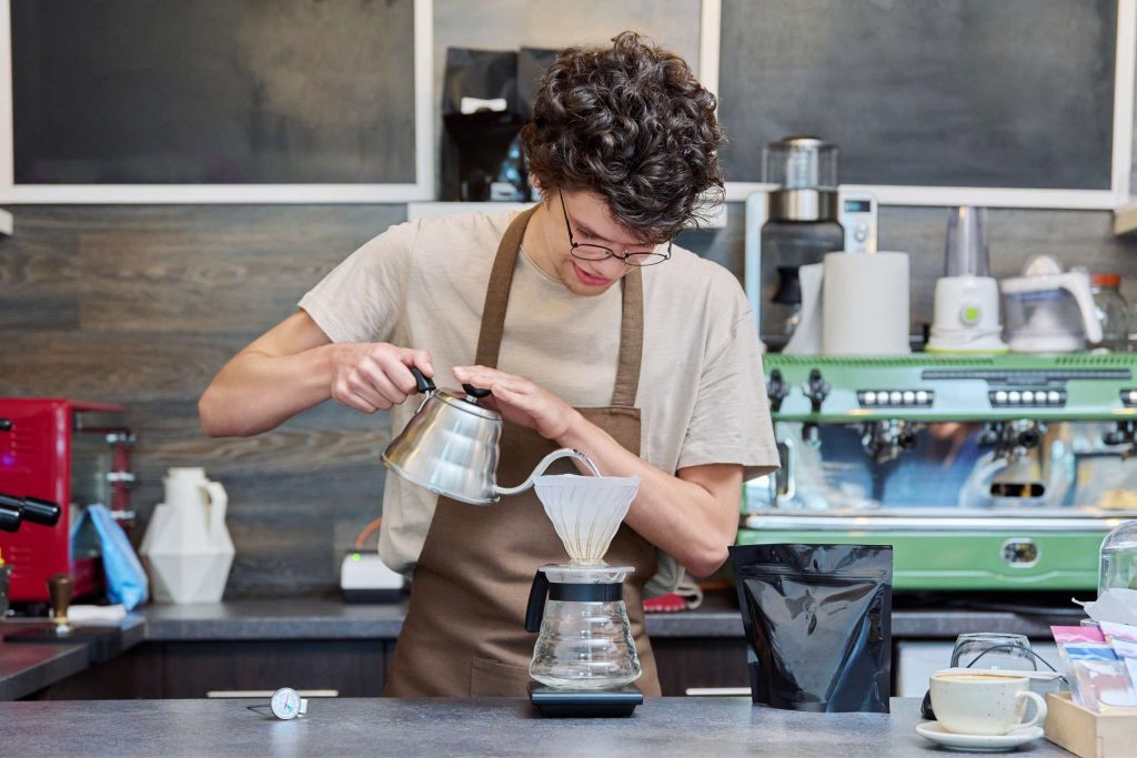 portrait of young guy barista worker at counter 2026 01 06 10 26 11 utc